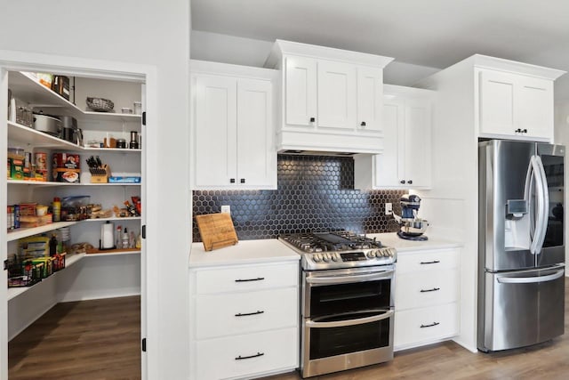 kitchen featuring light countertops, custom range hood, appliances with stainless steel finishes, white cabinets, and wood finished floors