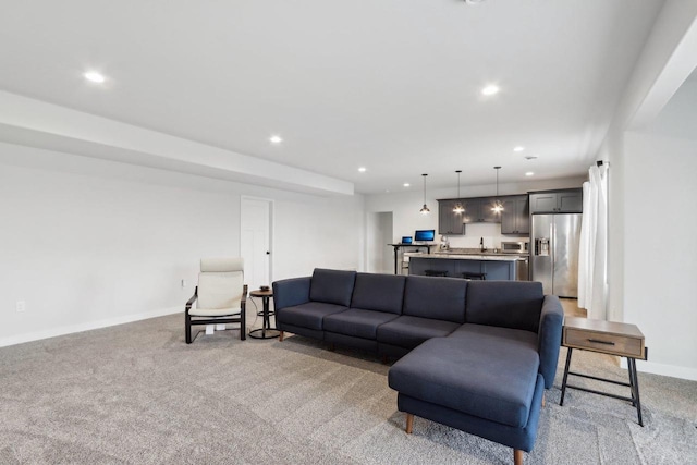 living area featuring light carpet, baseboards, and recessed lighting