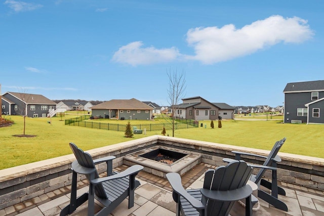 view of patio / terrace featuring a fenced backyard, a residential view, and a fire pit