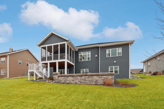 back of property featuring a sunroom, stairs, and a yard