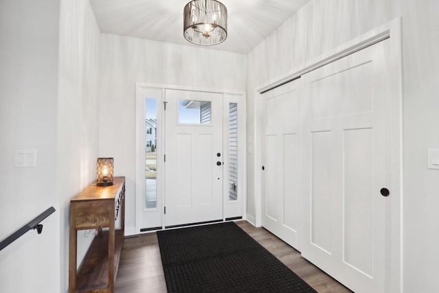 foyer with a chandelier and wood finished floors