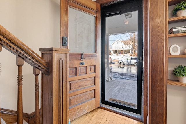 entryway with stairs and light wood finished floors