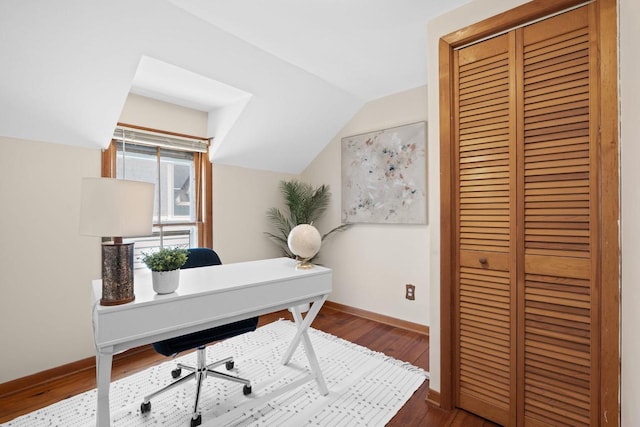 home office featuring vaulted ceiling, baseboards, and wood finished floors