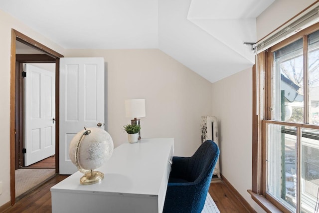 office with dark wood-style floors and vaulted ceiling