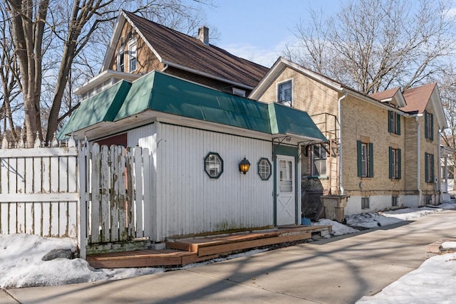 view of front of house with brick siding and fence