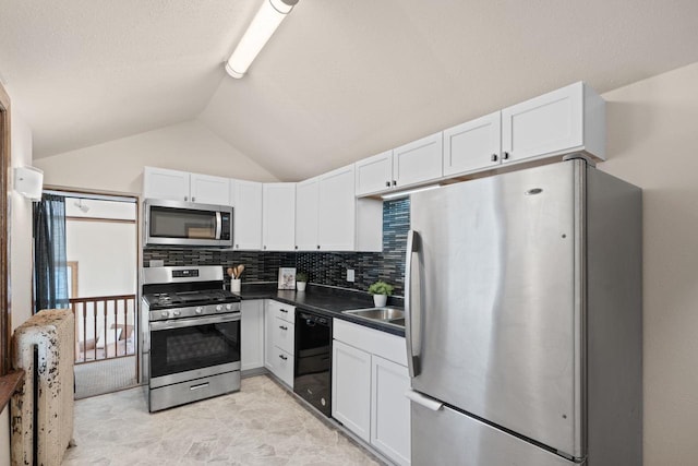 kitchen featuring dark countertops, white cabinets, and stainless steel appliances