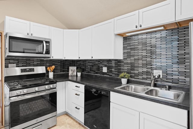 kitchen featuring appliances with stainless steel finishes, a sink, white cabinetry, and decorative backsplash