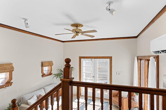 hallway featuring french doors, a healthy amount of sunlight, and crown molding