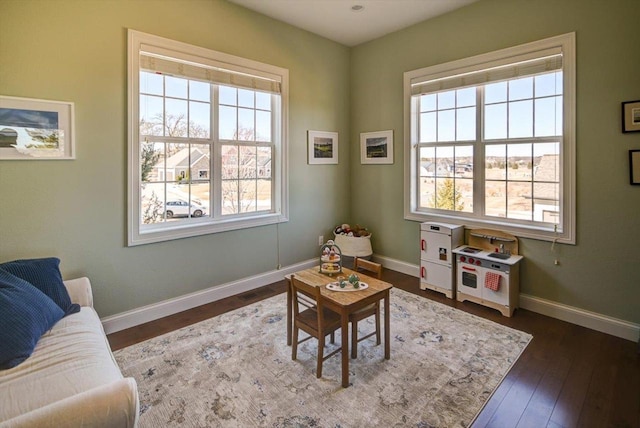 living area with dark wood-style floors and baseboards