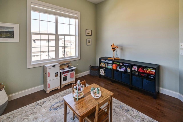 rec room with a healthy amount of sunlight, baseboards, and dark wood finished floors