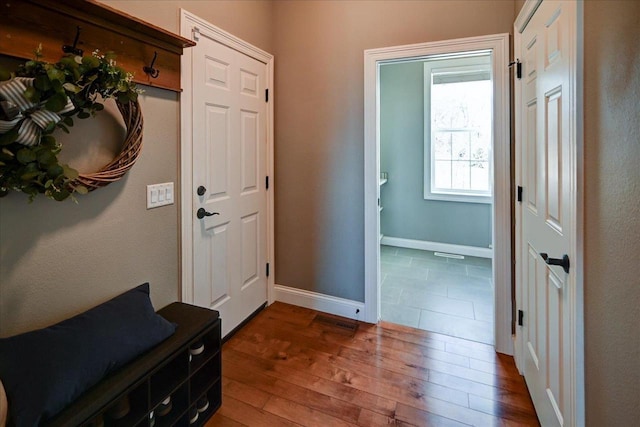 entrance foyer with baseboards and dark wood finished floors