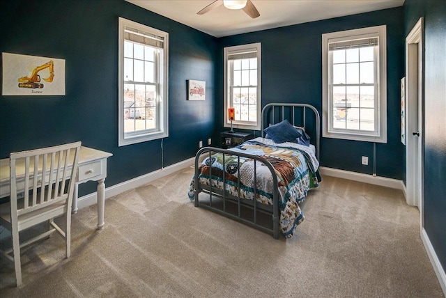 bedroom featuring light carpet, ceiling fan, and baseboards