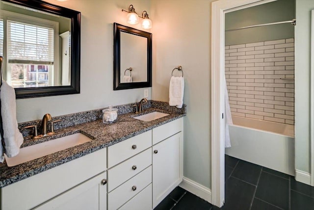 bathroom with double vanity, a sink, shower / tub combination, and tile patterned floors