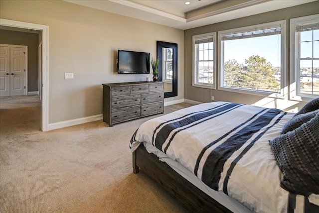 bedroom featuring baseboards, a tray ceiling, recessed lighting, and light colored carpet