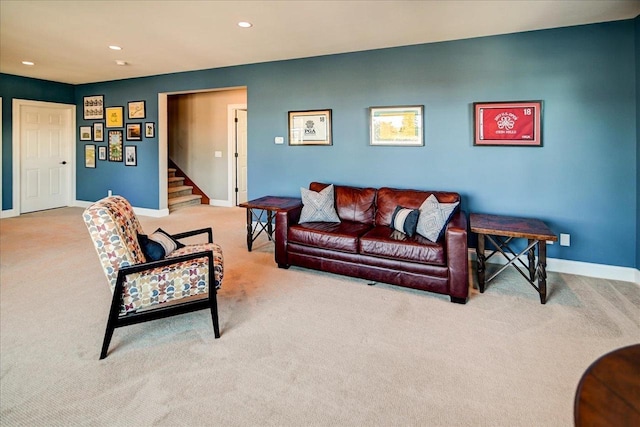 living area featuring recessed lighting, stairway, baseboards, and light colored carpet