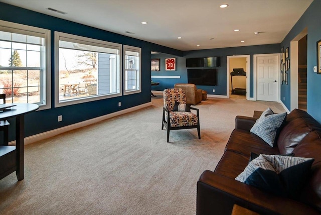 living room featuring light carpet, baseboards, and recessed lighting