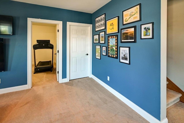 unfurnished bedroom with baseboards and light colored carpet