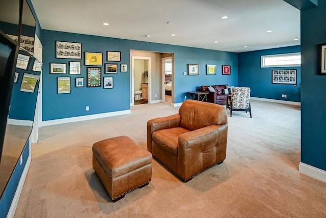 living area with recessed lighting, light colored carpet, and baseboards