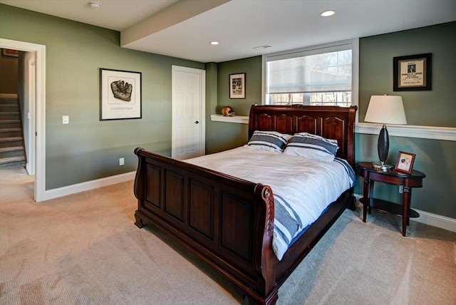 bedroom with light carpet, recessed lighting, and baseboards