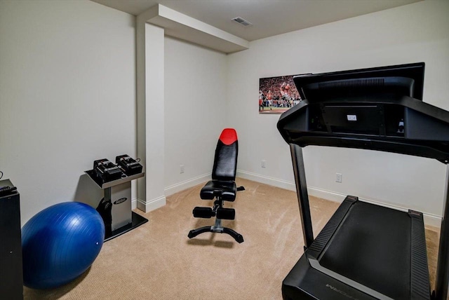 workout area with baseboards, visible vents, and light colored carpet