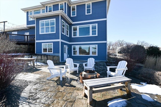 back of house with a patio and an outdoor fire pit