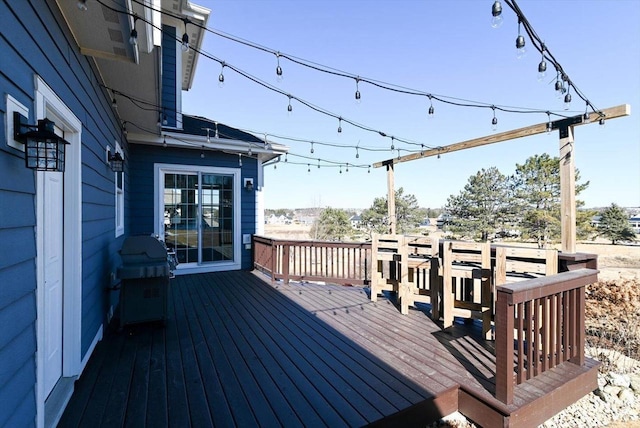 wooden terrace featuring area for grilling