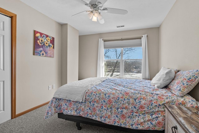 carpeted bedroom with a ceiling fan, visible vents, and baseboards