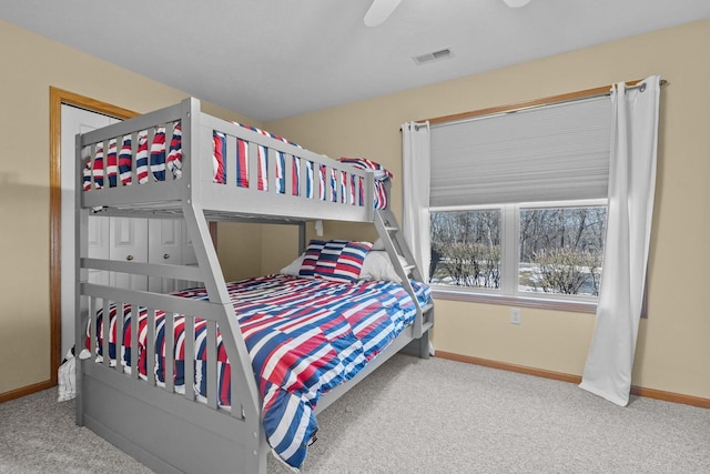 bedroom with carpet floors, visible vents, baseboards, and a ceiling fan