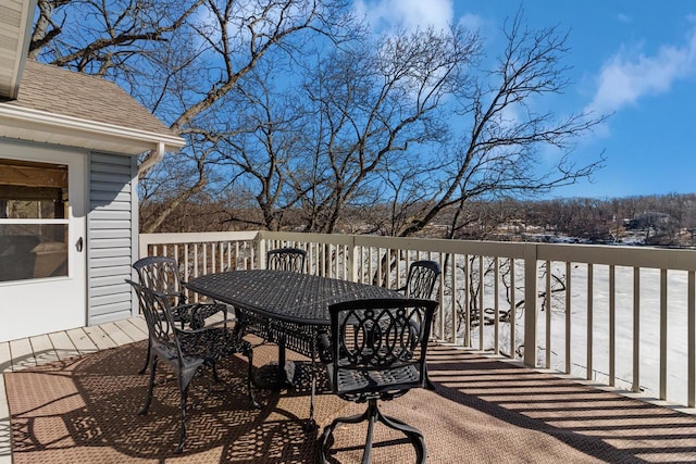 snow covered deck with outdoor dining space