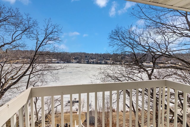 view of snow covered back of property