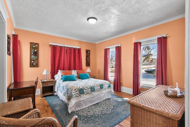 355 W Mill St, Columbus, WI 53925 - bedroom with ornamental molding, light wood-type flooring, and a textured ceiling