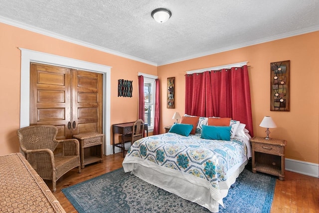 355 W Mill St, Columbus, WI 53925 - bedroom featuring wood finished floors, a textured ceiling, and crown molding