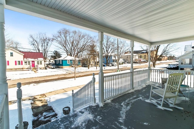355 W Mill St, Columbus, WI 53925 - snow covered patio featuring covered porch and a residential view