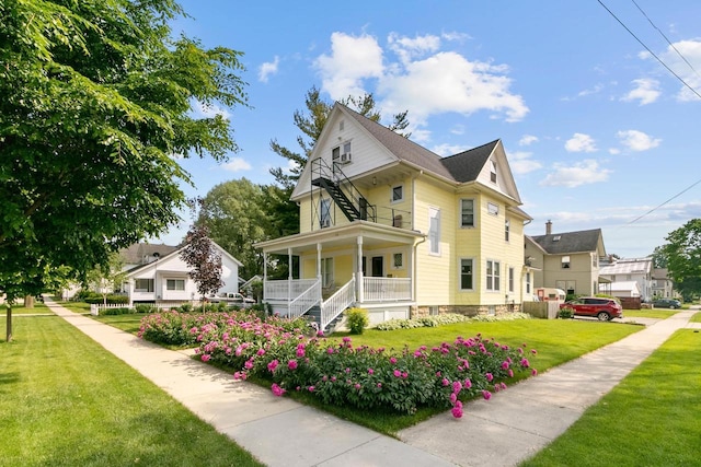 355 W Mill St, Columbus, WI 53925 - view of property exterior featuring a porch and a yard
