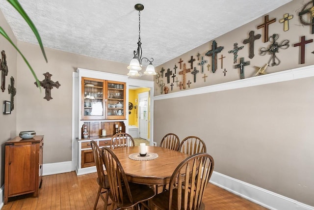 355 W Mill St, Columbus, WI 53925 - dining room with a textured ceiling, light wood-type flooring, and a chandelier