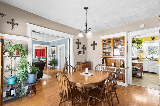 355 W Mill St, Columbus, WI 53925 - dining area with light wood-style floors, a chandelier, and a textured ceiling