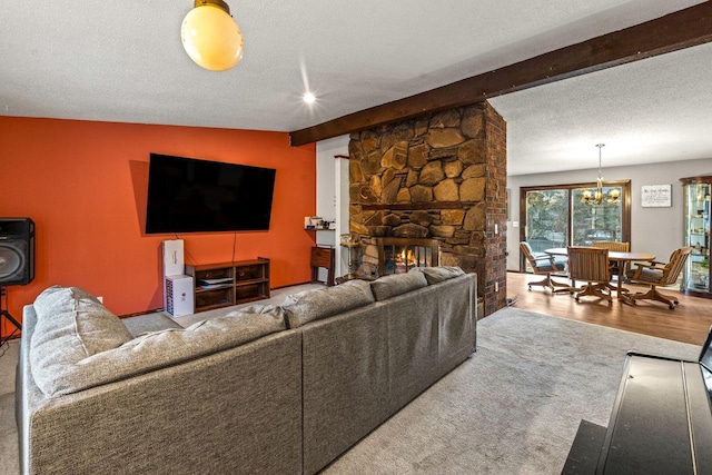 living area with vaulted ceiling with beams, a fireplace, an inviting chandelier, a textured ceiling, and wood finished floors