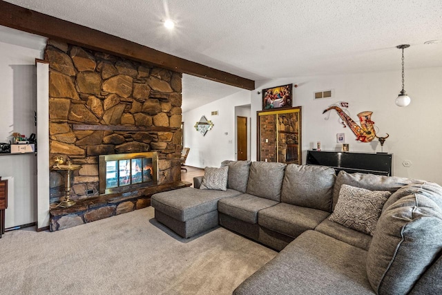 living room with vaulted ceiling with beams, a textured ceiling, light colored carpet, a fireplace, and visible vents