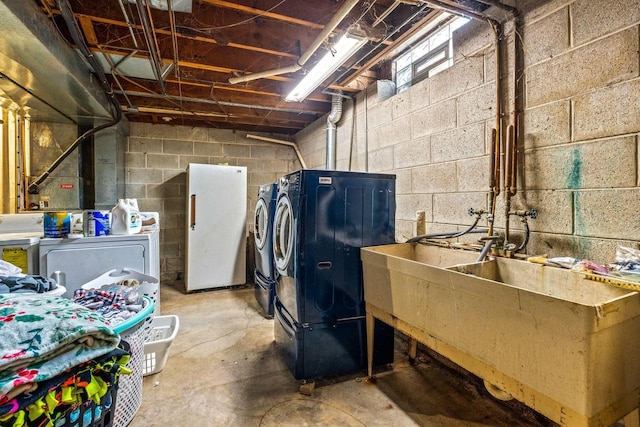 unfinished basement featuring washing machine and clothes dryer