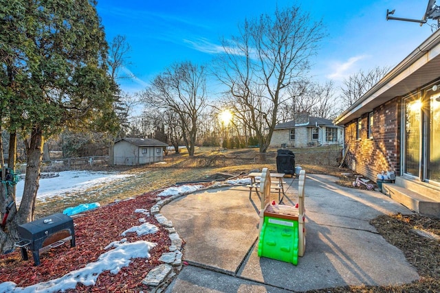 view of yard with entry steps, a storage shed, fence, an outdoor structure, and a patio area