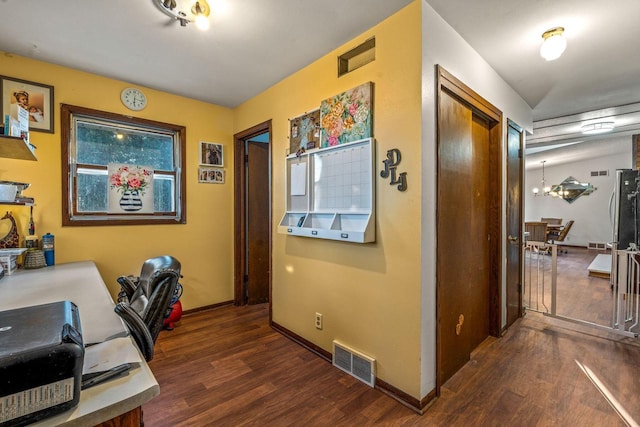 office featuring baseboards, visible vents, and dark wood-style flooring