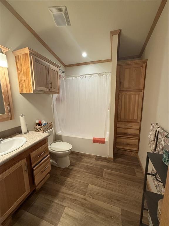 bathroom featuring wood finished floors, visible vents, vaulted ceiling, ornamental molding, and shower / tub combo with curtain