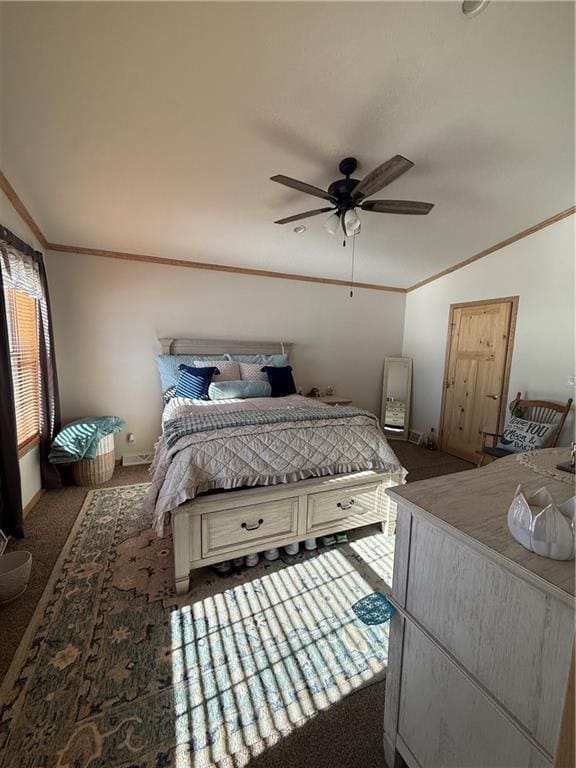 carpeted bedroom with vaulted ceiling, crown molding, baseboards, and ceiling fan