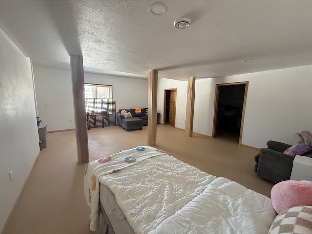 bedroom with light colored carpet, a textured ceiling, and baseboards