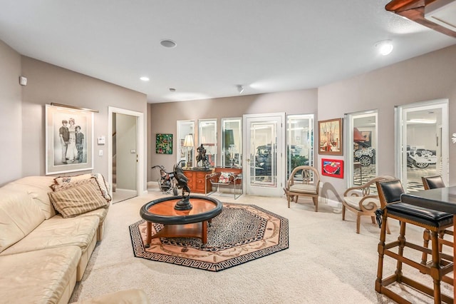 living area featuring carpet flooring and baseboards