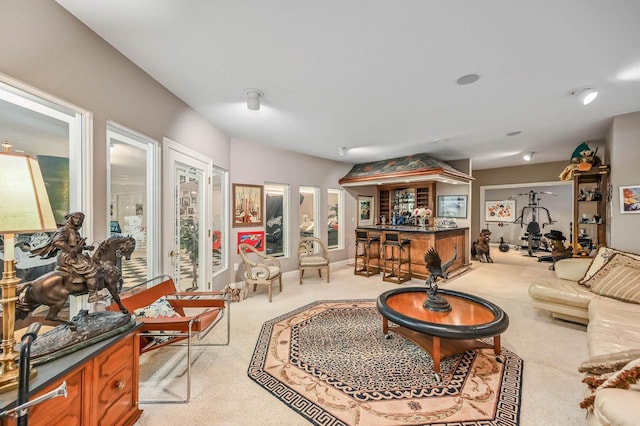 carpeted living room featuring a bar