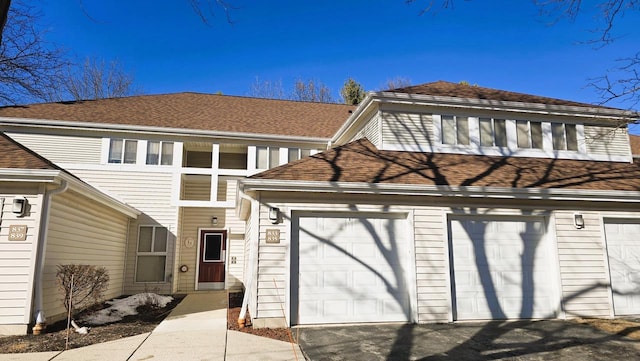 view of front of property with a garage and a shingled roof