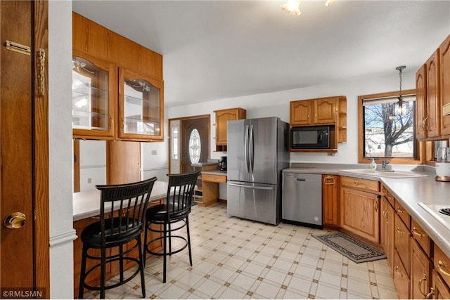 kitchen with light floors, plenty of natural light, stainless steel appliances, and a sink