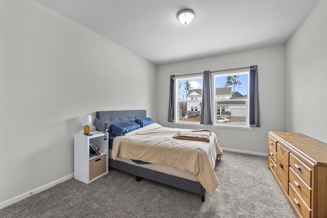 bedroom featuring baseboards and dark colored carpet