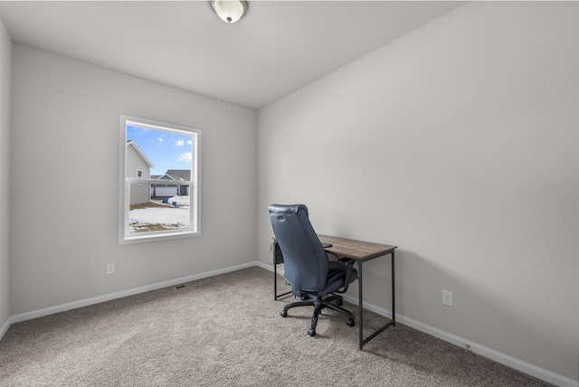 home office with carpet floors and baseboards